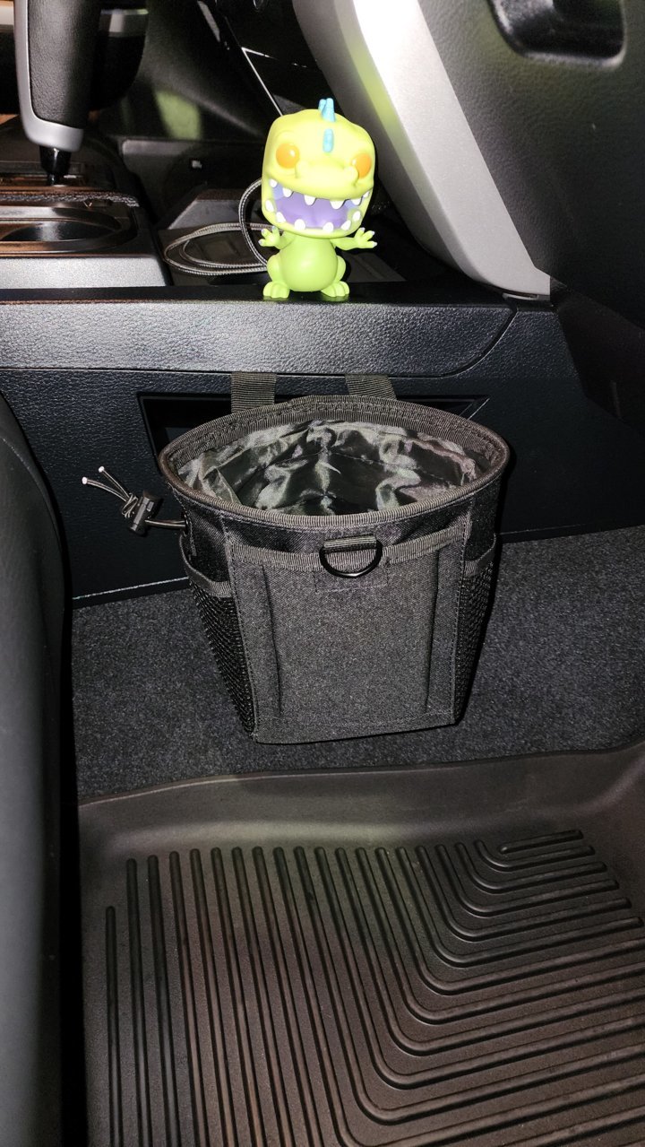Seeing a lot of people talking about larger water bottles not fitting in  the cup holders. I present to you the chalk bag from REI. Easy to install.  Holds just about any