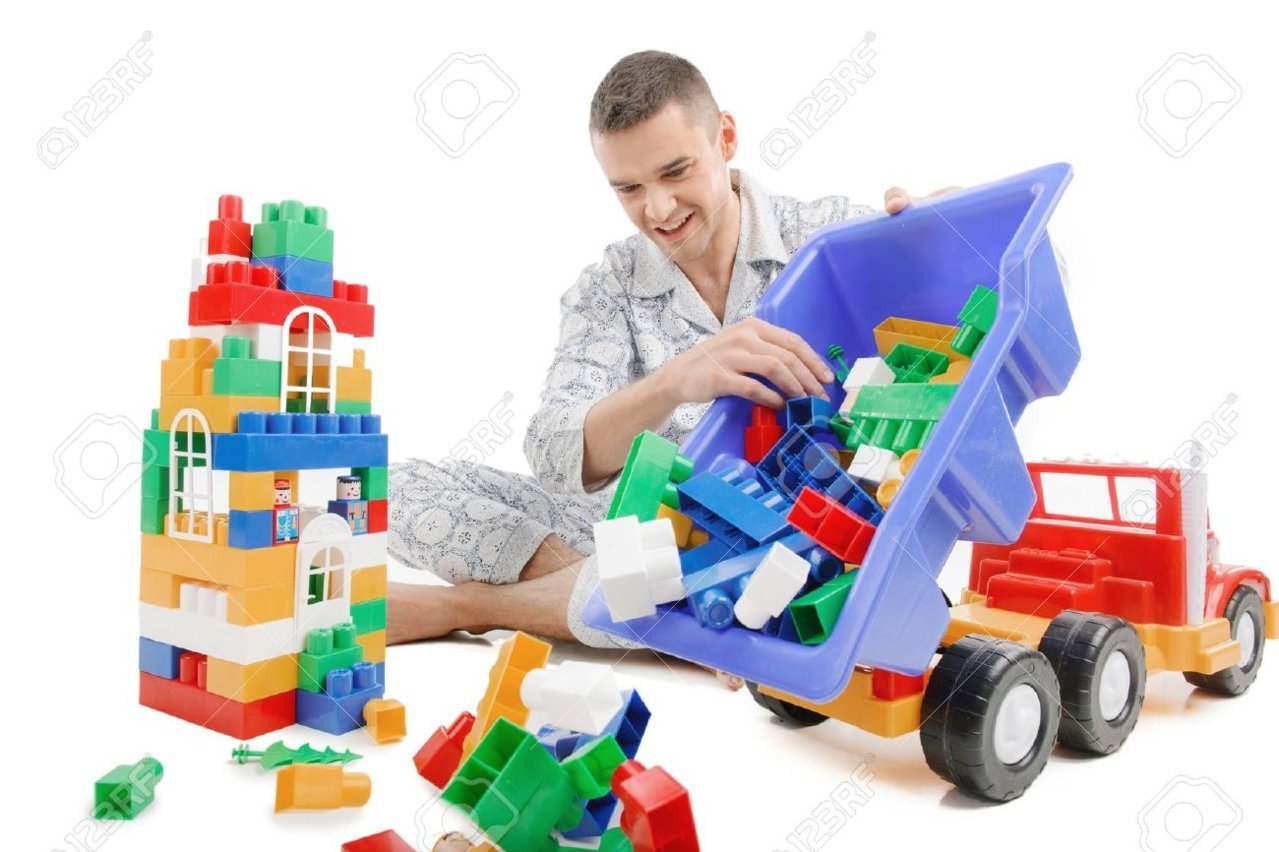 21986103-big-baby-excited-young-man-in-pajamas-playing-toys-while-isolated-on-white.jpg