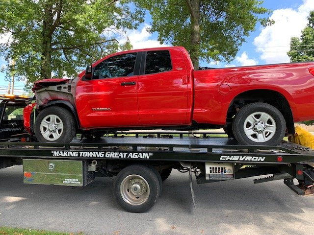 Tundra on tow to body shop.jpg