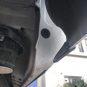 Underneath passenger side rear cab